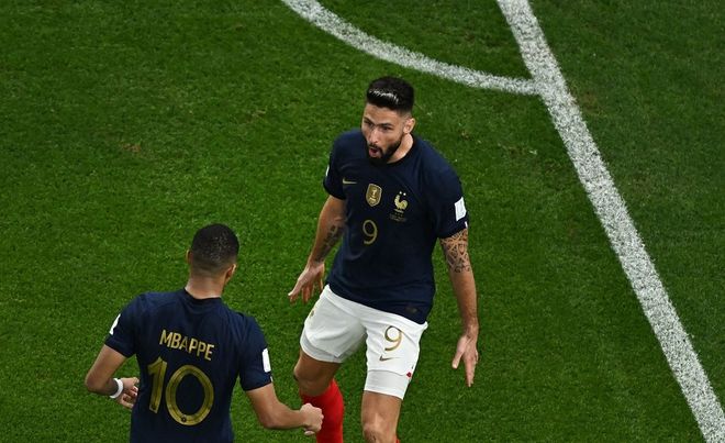 France's forward #09 Olivier Giroud celebrates with France's forward #10 Kylian Mbappe after scoring his team's first goal during the Qatar 2022 World Cup round of 16 football match between France and Poland at the Al-Thumama Stadium in Doha on December 4, 2022. (Photo by MANAN VATSYAYANA / AFP)