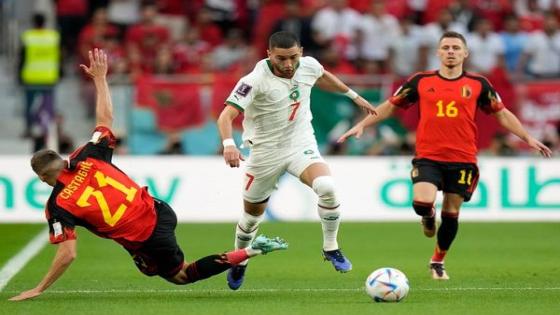 Morocco's Hakim Ziyech, centre, and Belgium's Timothy Castagne, left, fight for the ball, during the World Cup group F soccer match between Belgium and Morocco, at the Al Thumama Stadium in Doha, Qatar, Sunday, Nov. 27, 2022. (AP Photo/Alessandra Tarantino)